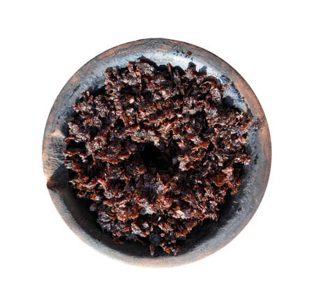 clay bowl with tobacco for smoking hookah top view on a white isolated backgroundの写真素材