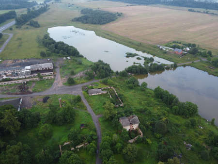 small village near a lake in summer aerial photoの写真素材