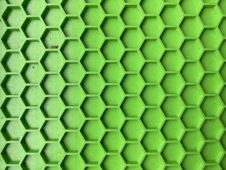 texture made of green plastic in the form of honeycombs close-up, abstract backgroundの写真素材