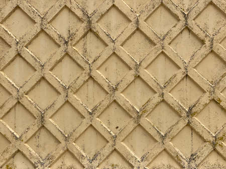 old concrete wall with embossed diamond patternの写真素材