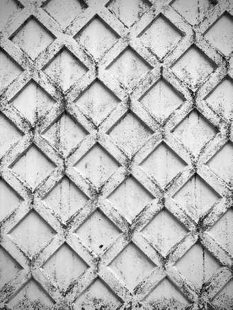 old concrete wall with embossed diamond patternの写真素材