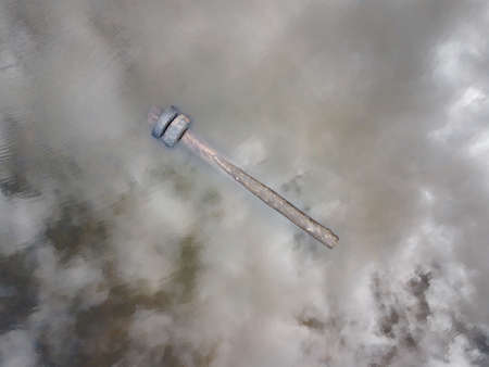 log with tires floating in a pond top view aerial photoの写真素材