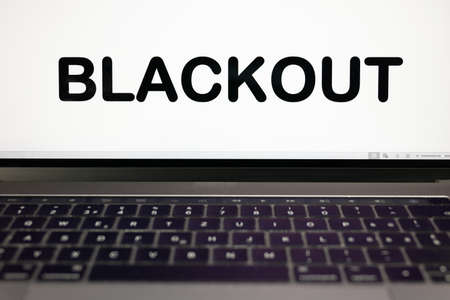 BLACKOUT sign with black letters on a laptop computer screenの写真素材