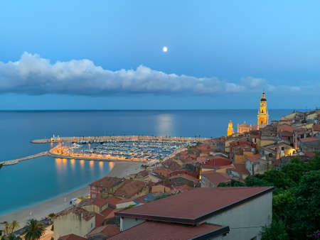 Menton, France - July 4, 2020: The evening descends to the Mediterranean tourist town of Menton on the French Riviera next ot Italian border.のeditorial素材