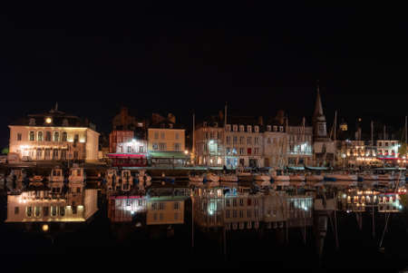 Honfleur, France - August 4, 2021: Honfleur at night, a french commune in the Calvados department and famous tourist resort in Normandy. Especially known for its old port.のeditorial素材