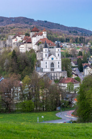 Aarburg, Switzerland - April 23, 2021: The castle of Aarburg in Switzerland and a reformed church are located high above the town Aarburg on a steep, rocky hillside.のeditorial素材