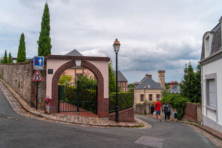 Honfleur, France - August 4, 2021: A family walking on the old street of Honfleur town in Normandyのeditorial素材