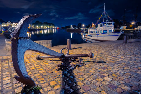 Honfleur, France - July 28, 2021: Blue hour scene with anchor at historical port of Honfleur, a french commune in the Calvados, Normandyのeditorial素材