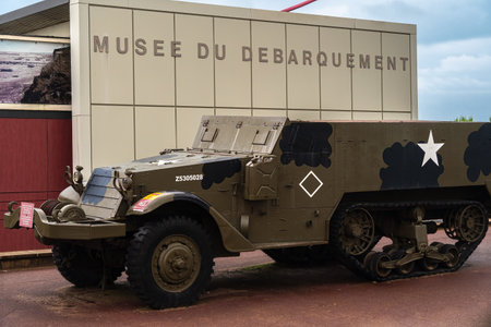 Arromanches, France - August 2, 2021: Musee du Debarquement - translation: Landing museum. Armored US military vehicle in front of the building.のeditorial素材