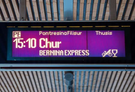Poschiavo, Switzerland - January 19, 2022: Digital billboard on the railway platform announcing the departure schedule of Bernina Express train from Poschiavo in direction of Chur, Switzerlandのeditorial素材