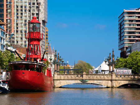 Rotterdam, Netherlands - April 28, 2022: Red ship Vesel II in Rotterdam, converted into a restaurant and modern residential buildingsのeditorial素材