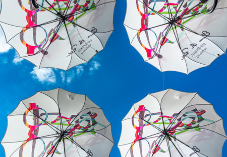 Wolfsburg, Germany - August 12, 2022: Bottom view of four decorative umbrellas in the air.のeditorial素材