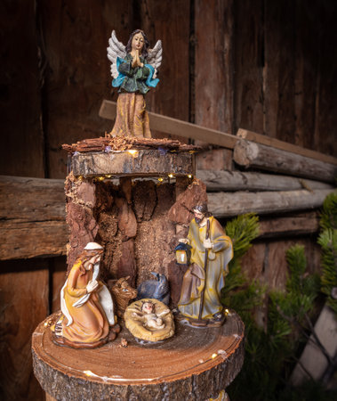Sutrio, Italy - December 29, 2022: Hand-made Christmas nativity scene with figurines of the holy family, angel and animalsのeditorial素材