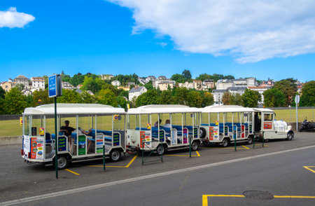 Lourdes, France - August 28, 2021: A small white train for tourists wishing to visit the town of Lourdes quickly and without fatigue.のeditorial素材