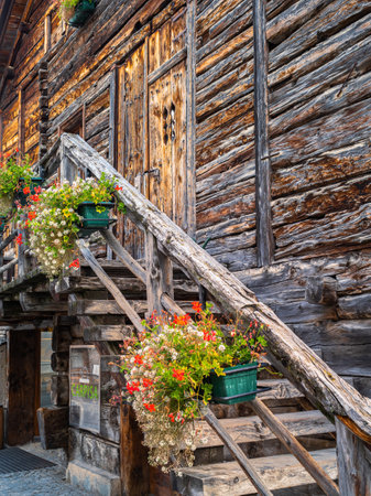 Facade of old wooden vintage house in alpine village of Livigno, Italyの写真素材