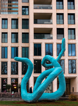 Frankfurt, Germany - January 29, 2023: Modern sculpture in front of a skyscraper in Frankfurt