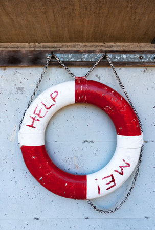 A lifebuoy in a natural swimming pool with the inscription Help me!の写真素材