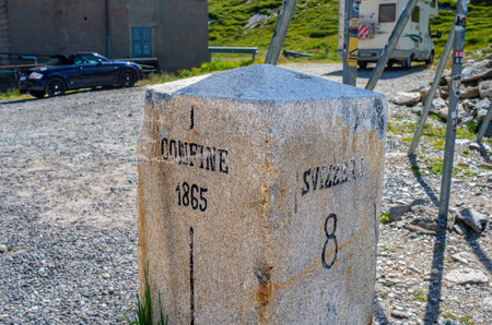 Splugenpass, Switzerland - July 9, 2023: The boundary stone between Switzerland and Italy at Splugenpass - Passo Splugaのeditorial素材