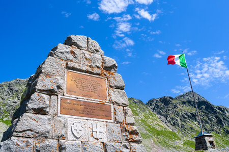 Splugenpass, Switzerland - July 9, 2023: Monument on the occasion of the renovation as well as a centenary of the road over the mountain pass Splugen - Spluga, which connects Switzerland and Italyのeditorial素材