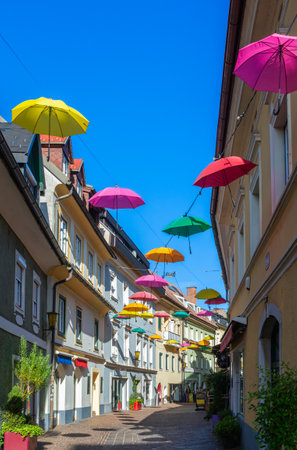 Villach, Austria - July 12, 2023: Colorful umbrellas hanging over the street of Villach, Austriaのeditorial素材