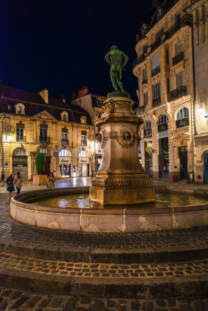 Dijon, France - August 8, 2023: The famous historical fountain in the square Francois Rude in Dijon, night photoのeditorial素材