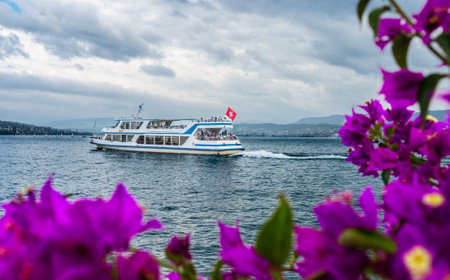 Zurich, Switzerland - July 7, 2023: A tourist ship with passengers leaves the Zurichhorn stop on Zurich lakeのeditorial素材