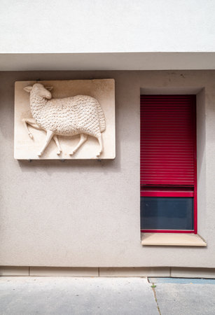 Dijon, France - August 8, 2023: Relief of sheep and a window on the facade of contemporary dwelling house in Dijonのeditorial素材