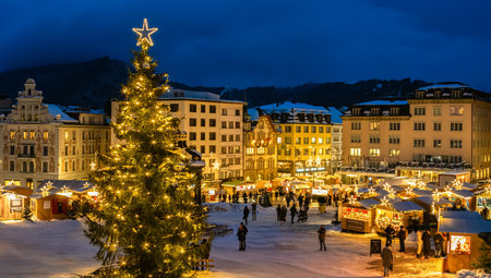 Einsiedeln, Switzerland - December 5, 2023: Christmas market and a big Cristmas tree in front of the Benedictine Abbey of Einsiedeln in blue hourのeditorial素材