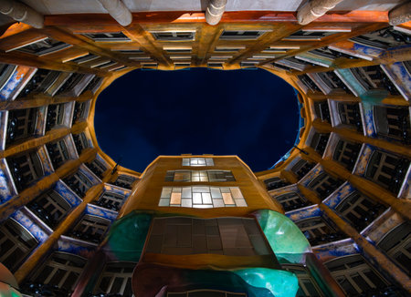 Barcelona, Spain - October 7, 2023: The colorful elliptic courtyard of Casa Mila - La Pedrera - made by the Catalan architect Antoni Gaudi. Blue hour.のeditorial素材