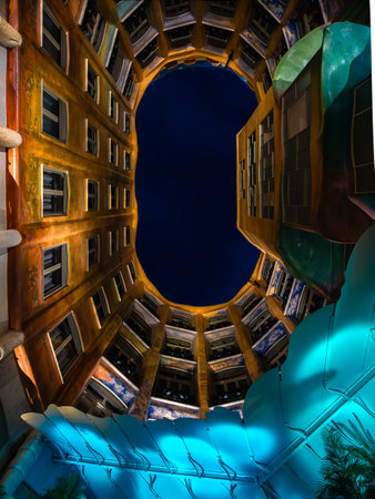 Barcelona, Spain - October 7, 2023: The colorful elliptic courtyard of Casa Mila - La Pedrera - made by the Catalan architect Antoni Gaudi. Blue hour.のeditorial素材