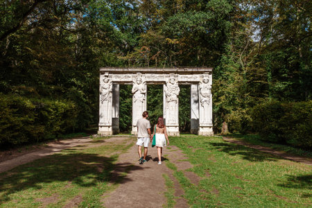 Chenonceaux, France - August 12, 2023: A young couple in love walking in the Chenonceaux castle gardenのeditorial素材