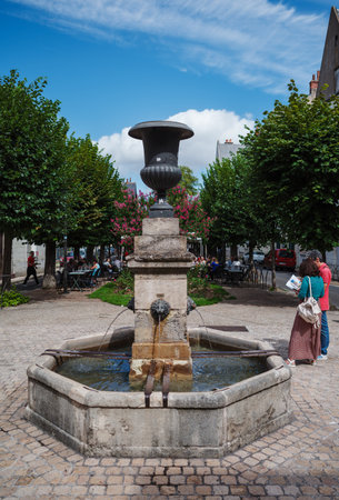 Tours, France - August 13, 2023: Tourists by a fountain in the old part of the city of Tours in the Loire Valleyのeditorial素材