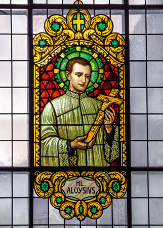 Zermatt, Switzerland - September 23, 2023: Stained glass window with the image of Saint Aloysius in the parish church of Saint Maurice in Zermattのeditorial素材