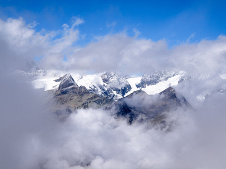 Idyllic view througs the cloud at the swiss mountain landscape on the Gornergrat above Zermatt in...