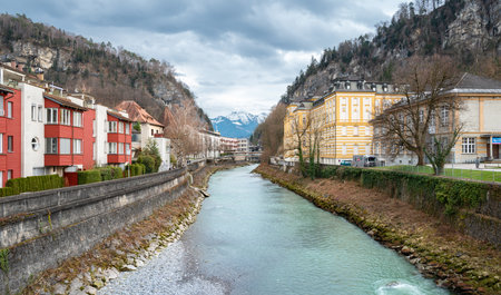 Feldkirch, Austria - March 15, 2024: Residential buildings left and the Vorarlberg State Conservatory right on the banks of river Illの写真素材