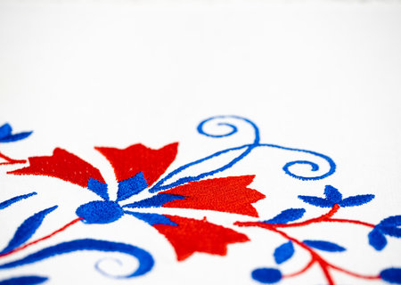 Traditional Slovenian tablecloth embroidery ornament in blue and red colors with carnation flower