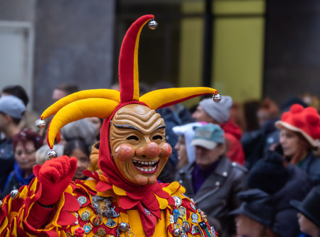 Freiburg in Breeisgau, Germany - February 12, 2024: Masquerade. Beautiful mask in a carnival parade with people blurred in background.のeditorial素材
