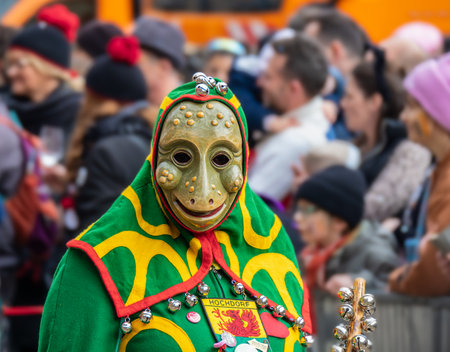 Freiburg in Breeisgau, Germany - February 12, 2024: Masquerade. Beautiful mask in a carnival parade with people blurred in background.のeditorial素材