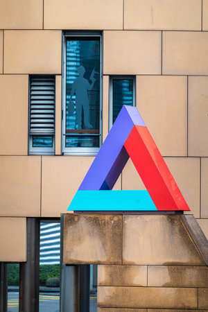 Basel, Switzerland - April 20, 2024: Triangle emblem - symbol - of Helvetia insurance companyのeditorial素材