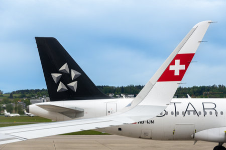 Zurich, Switzerland - April 28, 2024: Airplanes with symbols of Swiss and Star alliance airlinesのeditorial素材