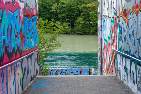 Geneva, Switzerland - September 25, 2025: Graffiti-covered walls frame a path leading to La Jonction...