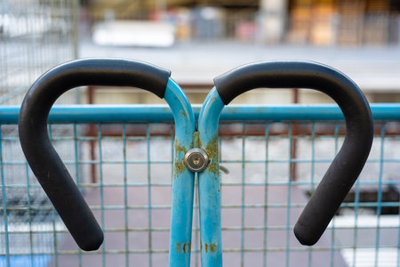 Close-up of a blue metal cart with black handles.の写真素材