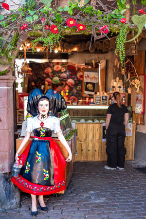 Ribeauville, France - August 24, 2025: A traditional Alsatian shop entrance in Ribeauville with a mannequin in folk costume.のeditorial素材