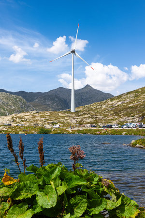 Gotthard pass, Switzerland - August 14, 2025: A scenic landscape of Gotthard pass, a wind turbine...