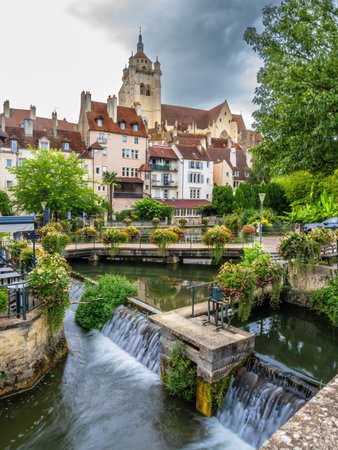 Dole, France - August 29, 2025: A picturesque view of a small town Dole in Burgundy with a river,...