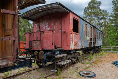 Sodertalje, Sweden - June 6, 2025: An abandoned vintage train car, showing signs of wear and...