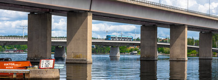 Stockholm, Sweden - June 10, 2025: A scenic view of a modern bridge in Stockholm spanning over a...