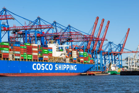 Hamburg, Germany - July 1, 2025: Busy industrial port of Hamburg with cranes and shipping...