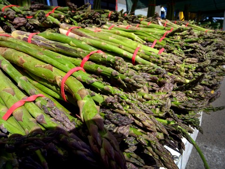 closeup of asparagus at a market stall with price tagの写真素材