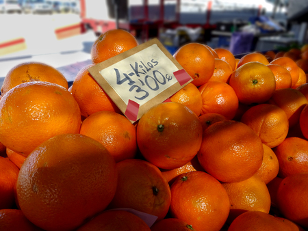 close-up of oranges at a market stall with tag priceの写真素材